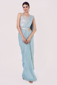 Shop light blue drape saree embedded with mirror work. Make a fashion statement on festive occasions and weddings with designer sarees, designer suits, Indian dresses, Anarkali suits, palazzo suits, designer gowns, sharara suits, and embroidered sarees from Pure Elegance Indian fashion store in the USA.