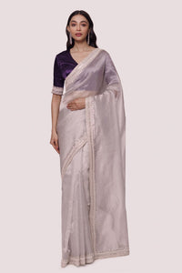 Shop grey saree with Indian embroidered contrasting purple blouse. Make a fashion statement on festive occasions and weddings with designer sarees, designer suits, Indian dresses, Anarkali suits, palazzo suits, designer gowns, sharara suits, and embroidered sarees from Pure Elegance Indian fashion store in the USA.