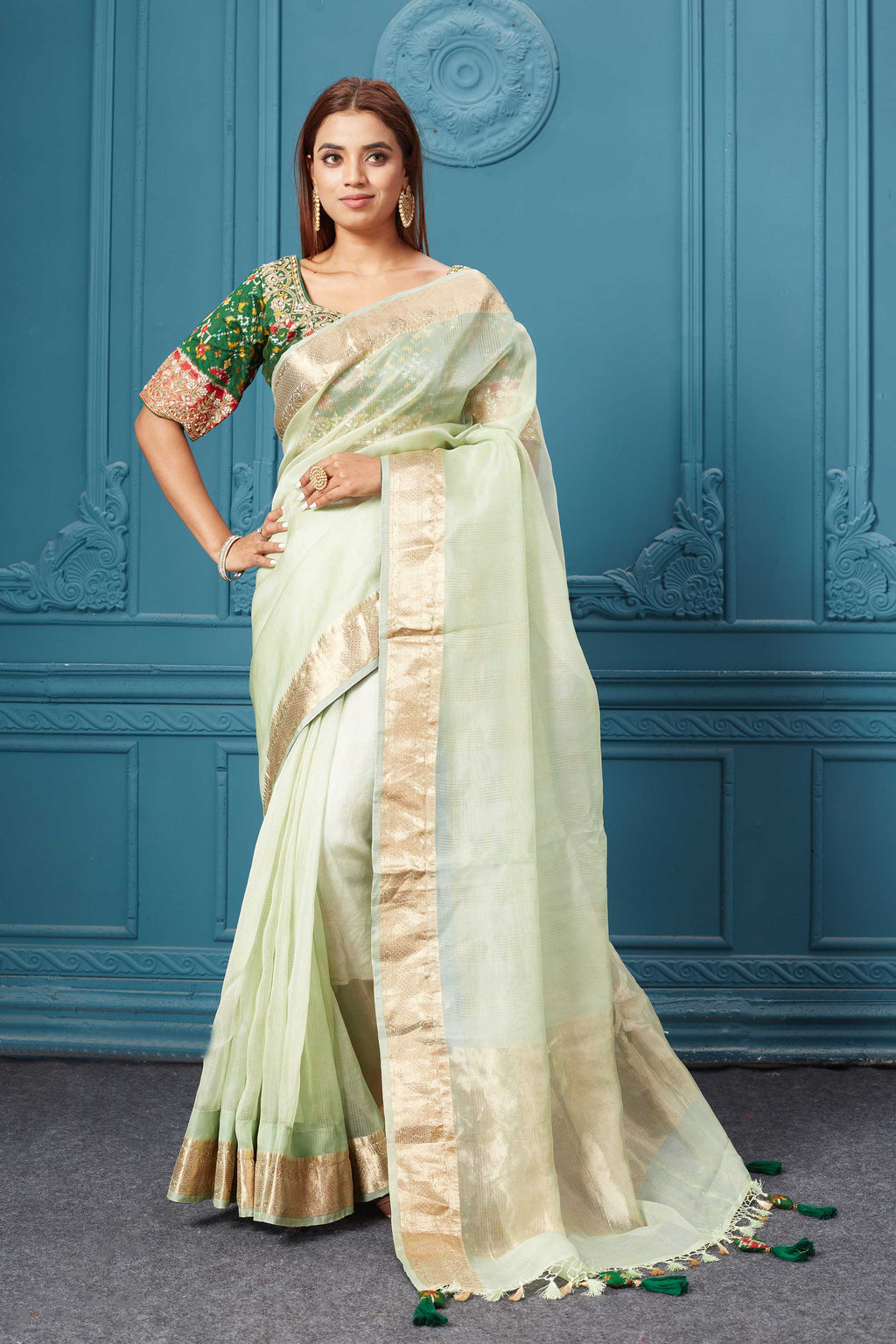 Shop pista green organza silk saree online in USA with green Patola embroidered blouse. Look royal at weddings and festive occasions in exquisite designer sarees, handwoven sarees, pure silk saris, Banarasi sarees, Kanchipuram silk sarees from Pure Elegance Indian saree store in USA. -full view