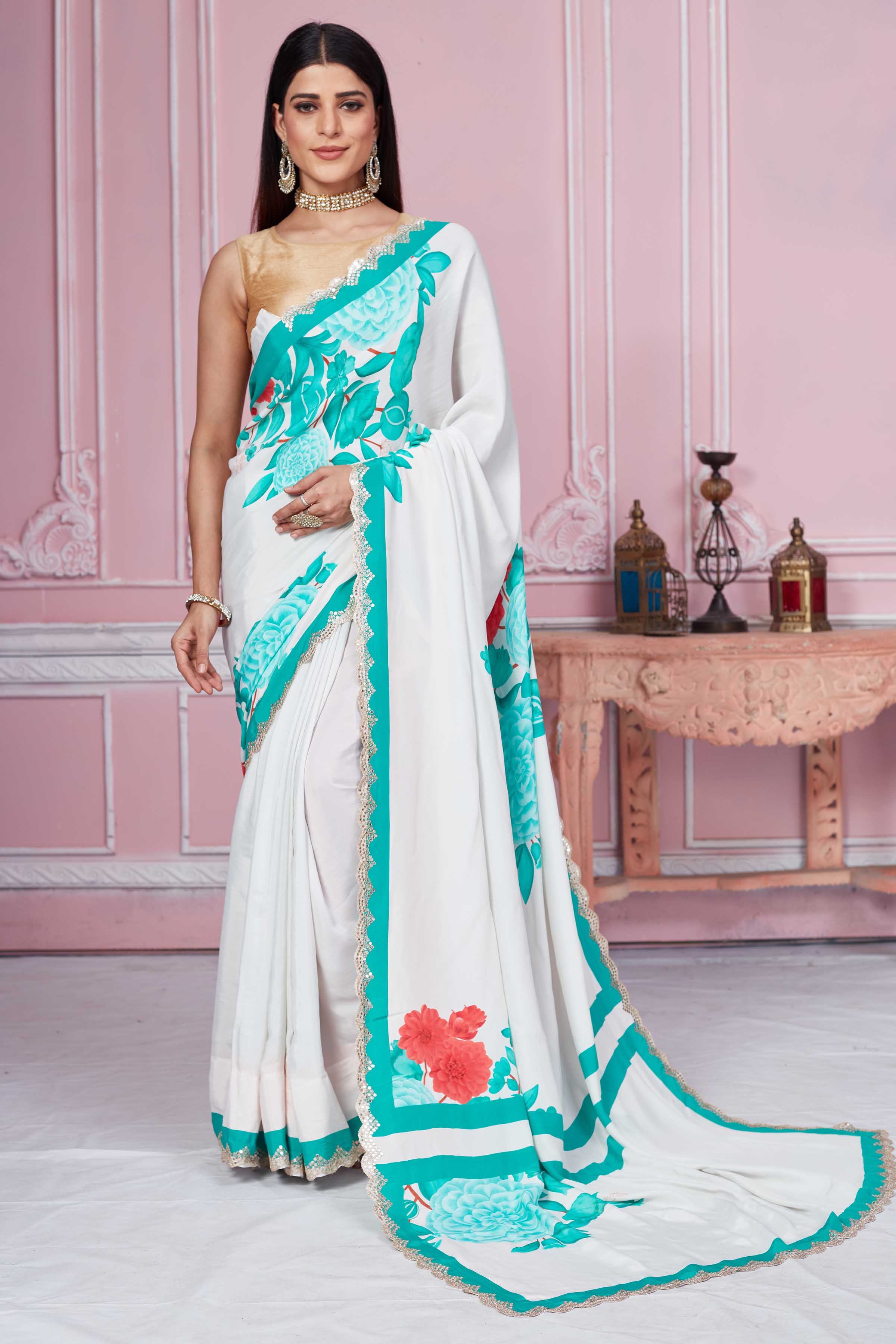 Buy off-white green floral crepe saree online in USA with scalloped border. Look your best on festive occasions in latest designer sarees, pure silk sarees, Kanjivaram silk saris, handwoven saris, tussar silk sarees, embroidered saris from Pure Elegance Indian clothing store in USA.-full view