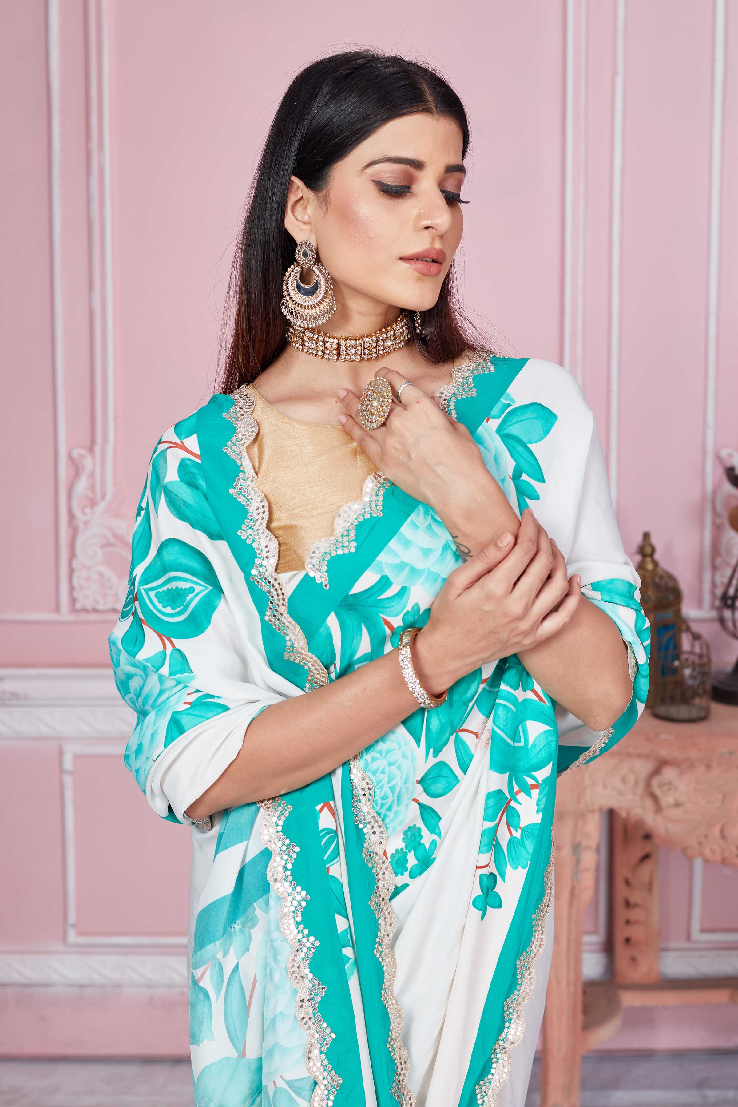 Buy off-white green floral crepe saree online in USA with scalloped border. Look your best on festive occasions in latest designer sarees, pure silk sarees, Kanjivaram silk saris, handwoven saris, tussar silk sarees, embroidered saris from Pure Elegance Indian clothing store in USA.-closeup