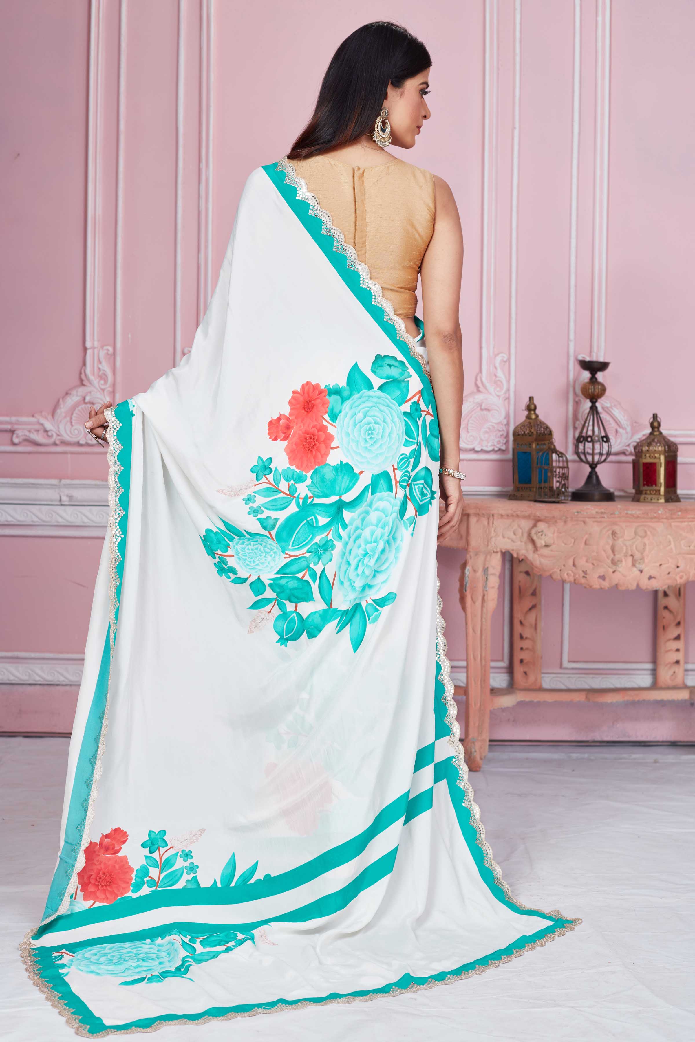 Buy off-white green floral crepe saree online in USA with scalloped border. Look your best on festive occasions in latest designer sarees, pure silk sarees, Kanjivaram silk saris, handwoven saris, tussar silk sarees, embroidered saris from Pure Elegance Indian clothing store in USA.-back