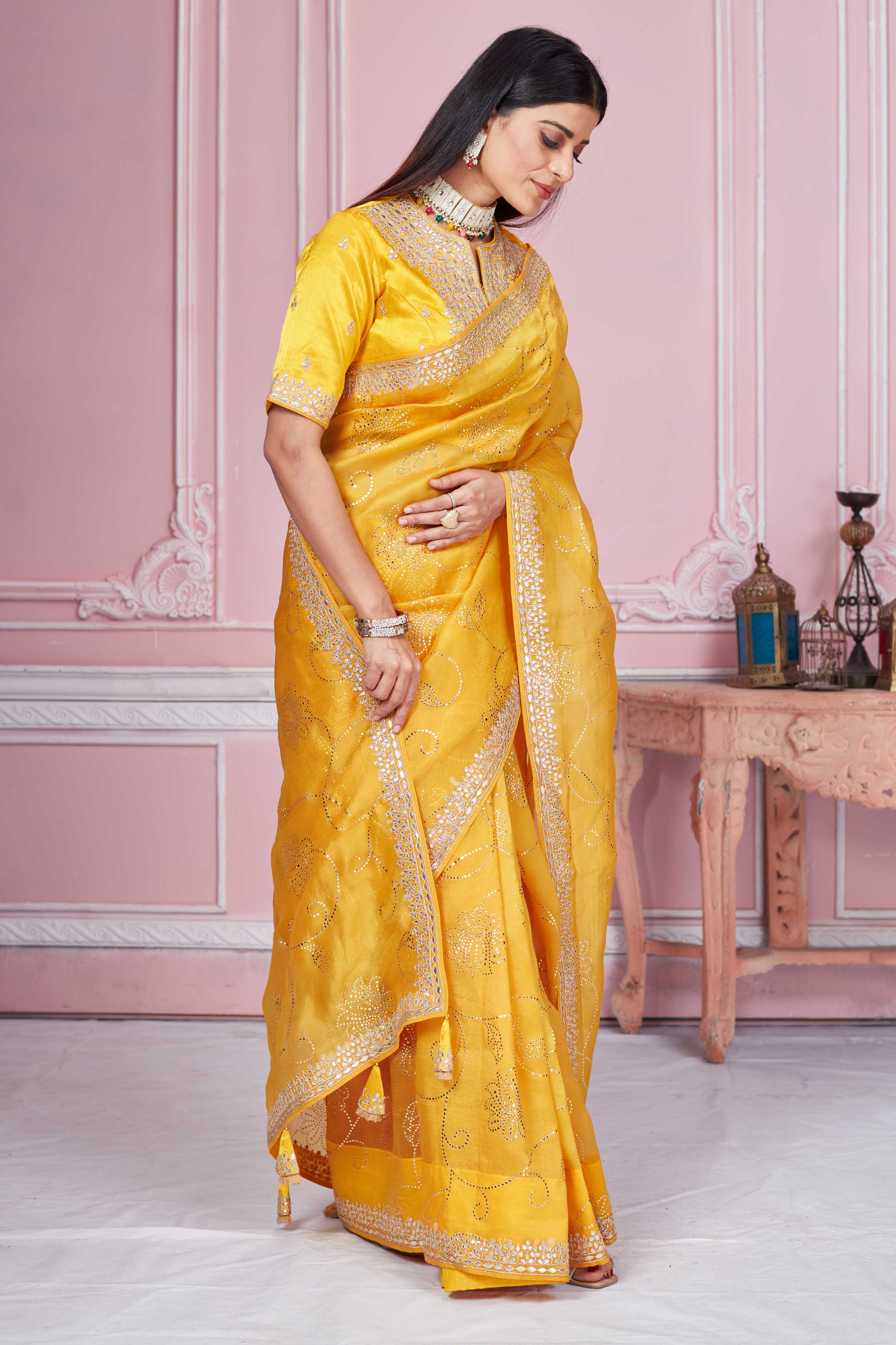 Buy yellow gota patti embroidery organza sari online in USA with blouse. Look your best on festive occasions in latest designer sarees, pure silk sarees, Kanjivaram silk saris, handwoven saris, tussar silk sarees, embroidered saris from Pure Elegance Indian clothing store in USA.-side