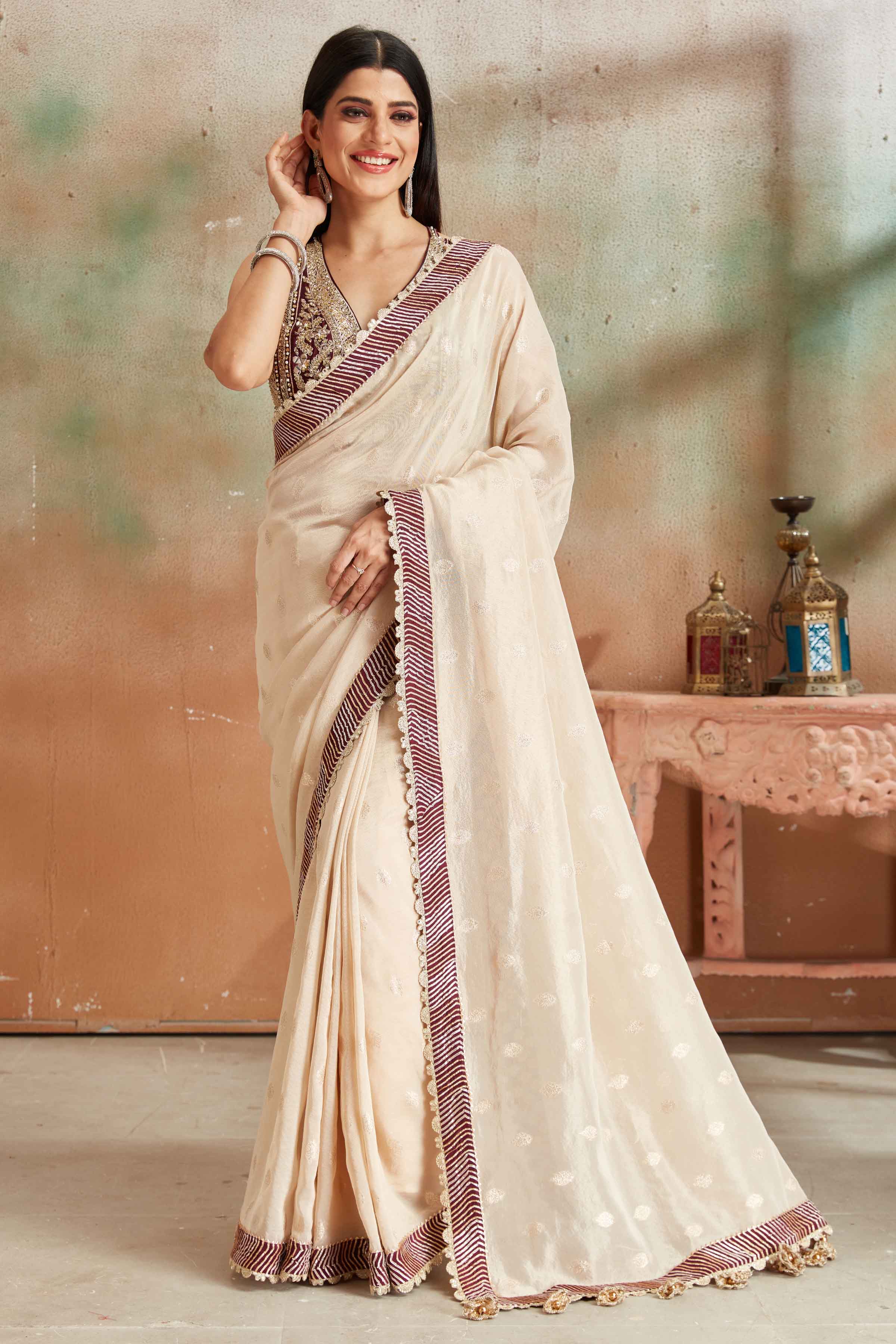 Shop beautiful cream embroidered georgette sari online in USA with maroon border. Look your best on festive occasions in latest designer saris, pure silk sarees, Kanjivaram silk sarees, handwoven saris, tussar silk sarees, embroidered saris from Pure Elegance Indian clothing store in USA.-front