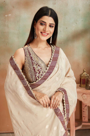 Shop beautiful cream embroidered georgette sari online in USA with maroon border. Look your best on festive occasions in latest designer saris, pure silk sarees, Kanjivaram silk sarees, handwoven saris, tussar silk sarees, embroidered saris from Pure Elegance Indian clothing store in USA.-closeup