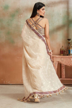 Shop beautiful cream embroidered georgette sari online in USA with maroon border. Look your best on festive occasions in latest designer saris, pure silk sarees, Kanjivaram silk sarees, handwoven saris, tussar silk sarees, embroidered saris from Pure Elegance Indian clothing store in USA.-back