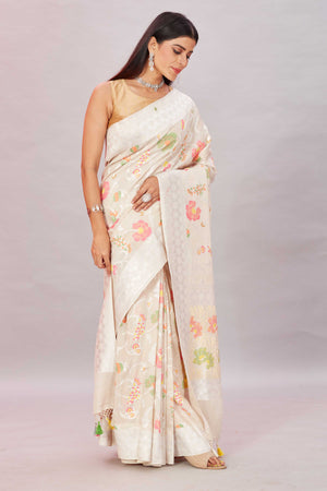 Shop off-white tussar Benarasi sari online in USA with zari minakari floral jaal. Look your best on festive occasions in latest designer sarees, pure silk sarees, Kanjivaram silk sarees, handwoven saris, tussar silk sarees, embroidered saris from Pure Elegance Indian clothing store in USA.-side