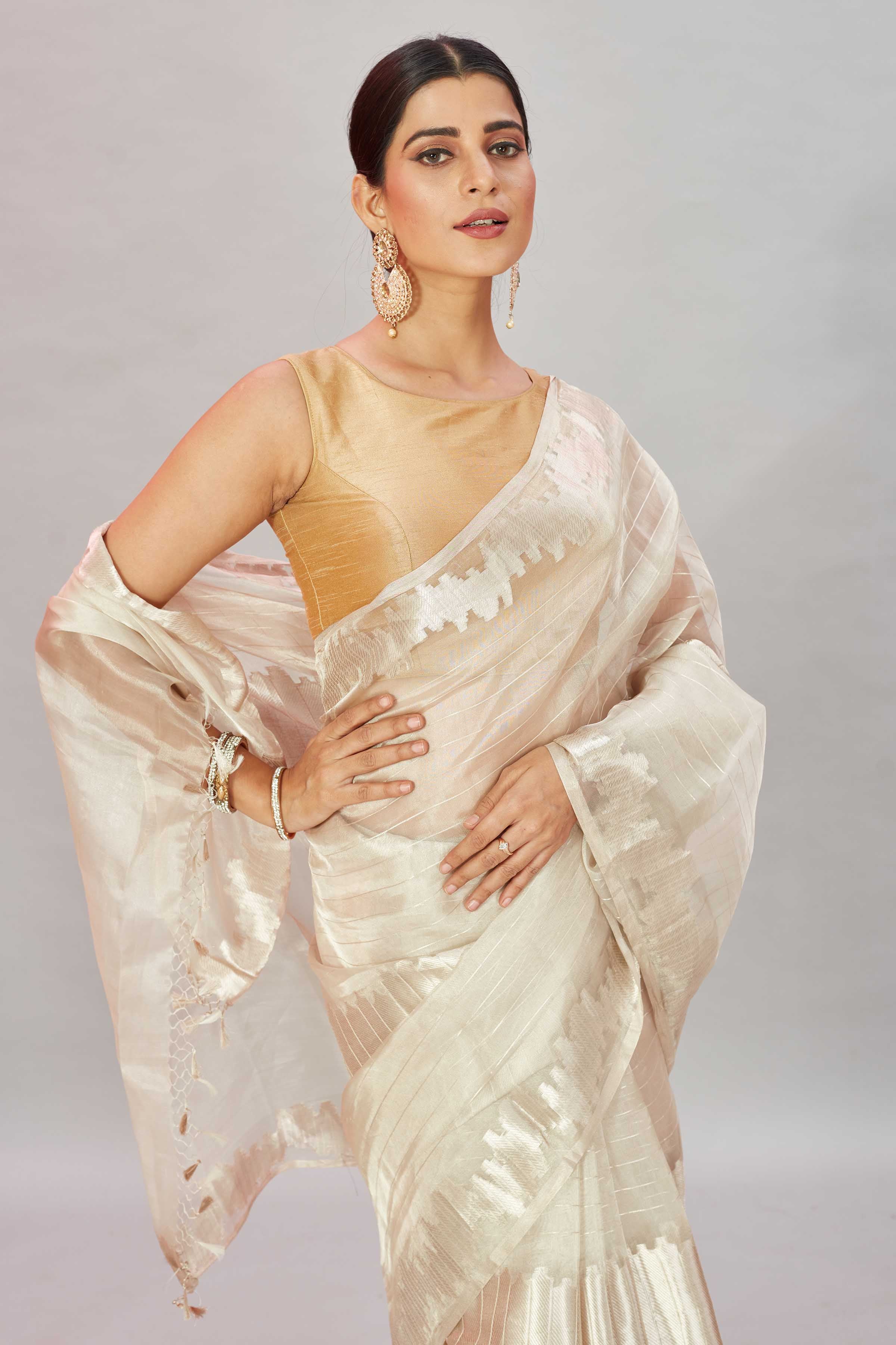 Shop stunning cream zari work tissue Banarasi saree online in USA. Look your best on festive occasions in latest designer sarees, pure silk sarees, Kanjivaram silk saris, handwoven saris, tussar silk sarees, embroidered saris from Pure Elegance Indian clothing store in USA.-closeup