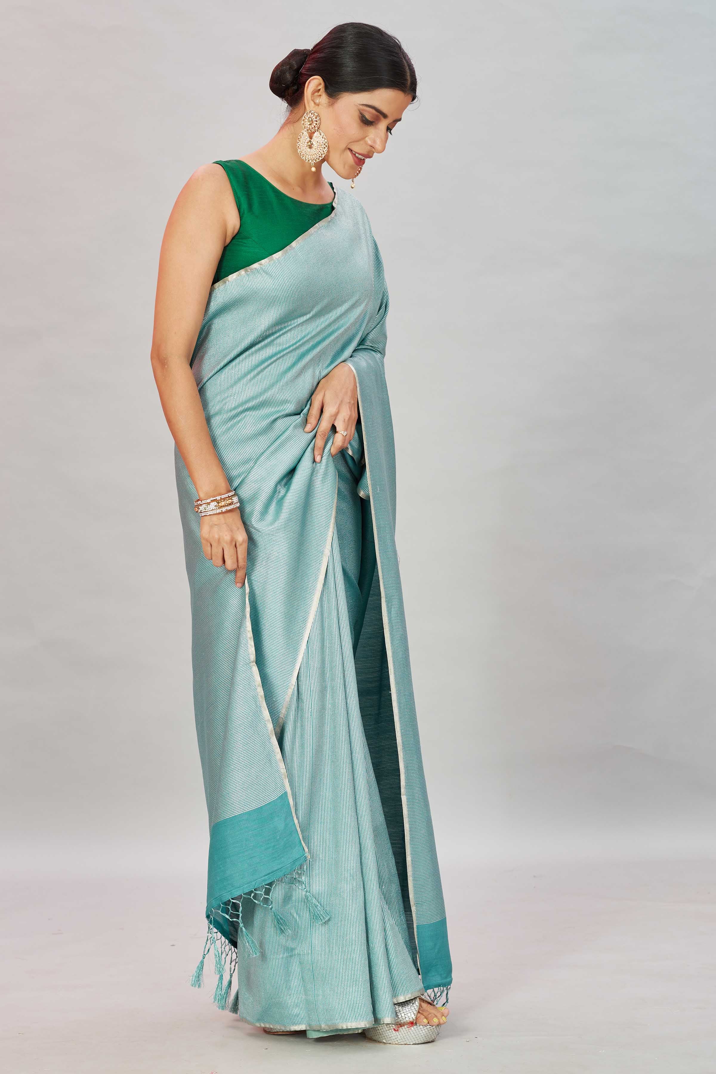 Shop green zari stripes Muga Banarasi sari online in USA. Look your best on festive occasions in latest designer saris, pure silk sarees, Kanjivaram silk sarees, handwoven saris, tussar silk sarees, embroidered saris from Pure Elegance Indian clothing store in USA.-side