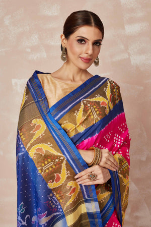 Shop pink Patola bandhej saree online in USA with brown blue border. Look your best on festive occasions in latest designer sarees, pure silk sarees, Kanjivaram silk saris, handwoven saris, tussar silk sarees, embroidered saris from Pure Elegance Indian clothing store in USA.-closeup