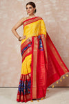 Shop yellow bandhej sari online in USA with blue red ikkat zari border and pallu. Look your best on festive occasions in latest designer sarees, pure silk sarees, Kanjivaram silk saris, handwoven saris, tussar silk sarees, embroidered saris from Pure Elegance Indian clothing store in USA.-full view