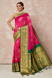 Shop pink bandhej saree online in USA with green zari border and pallu. Look your best on festive occasions in latest designer sarees, pure silk sarees, Kanjivaram silk saris, handwoven saris, tussar silk sarees, embroidered saris from Pure Elegance Indian clothing store in USA.-full view