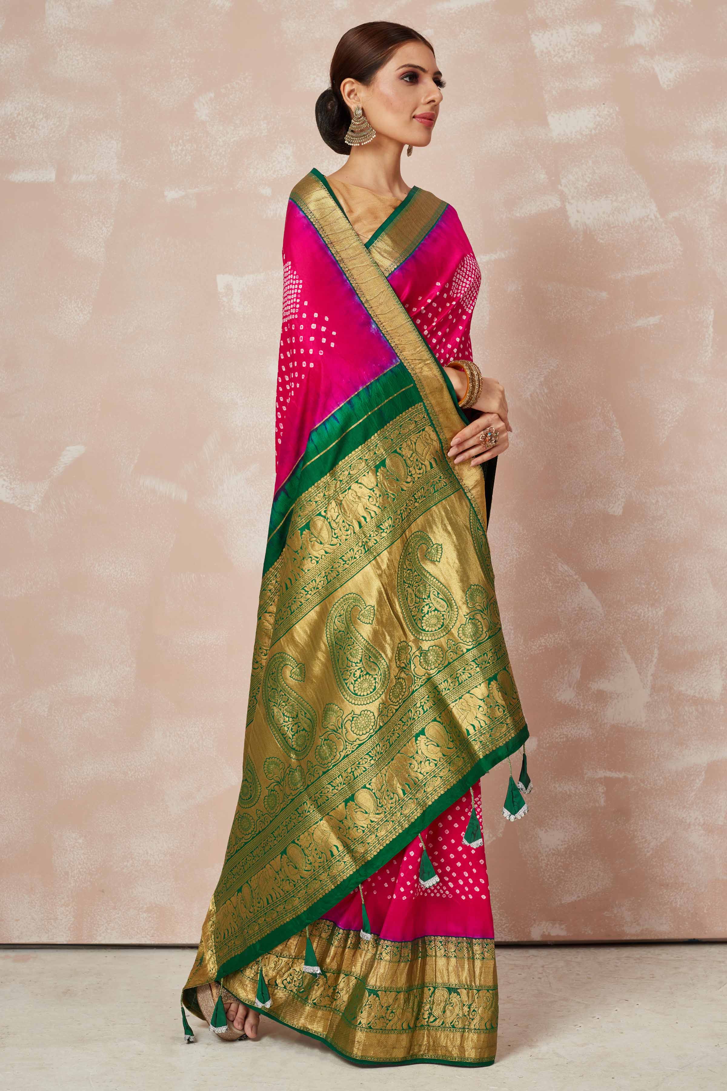 Shop pink bandhej saree online in USA with green zari border and pallu. Look your best on festive occasions in latest designer sarees, pure silk sarees, Kanjivaram silk saris, handwoven saris, tussar silk sarees, embroidered saris from Pure Elegance Indian clothing store in USA.-side