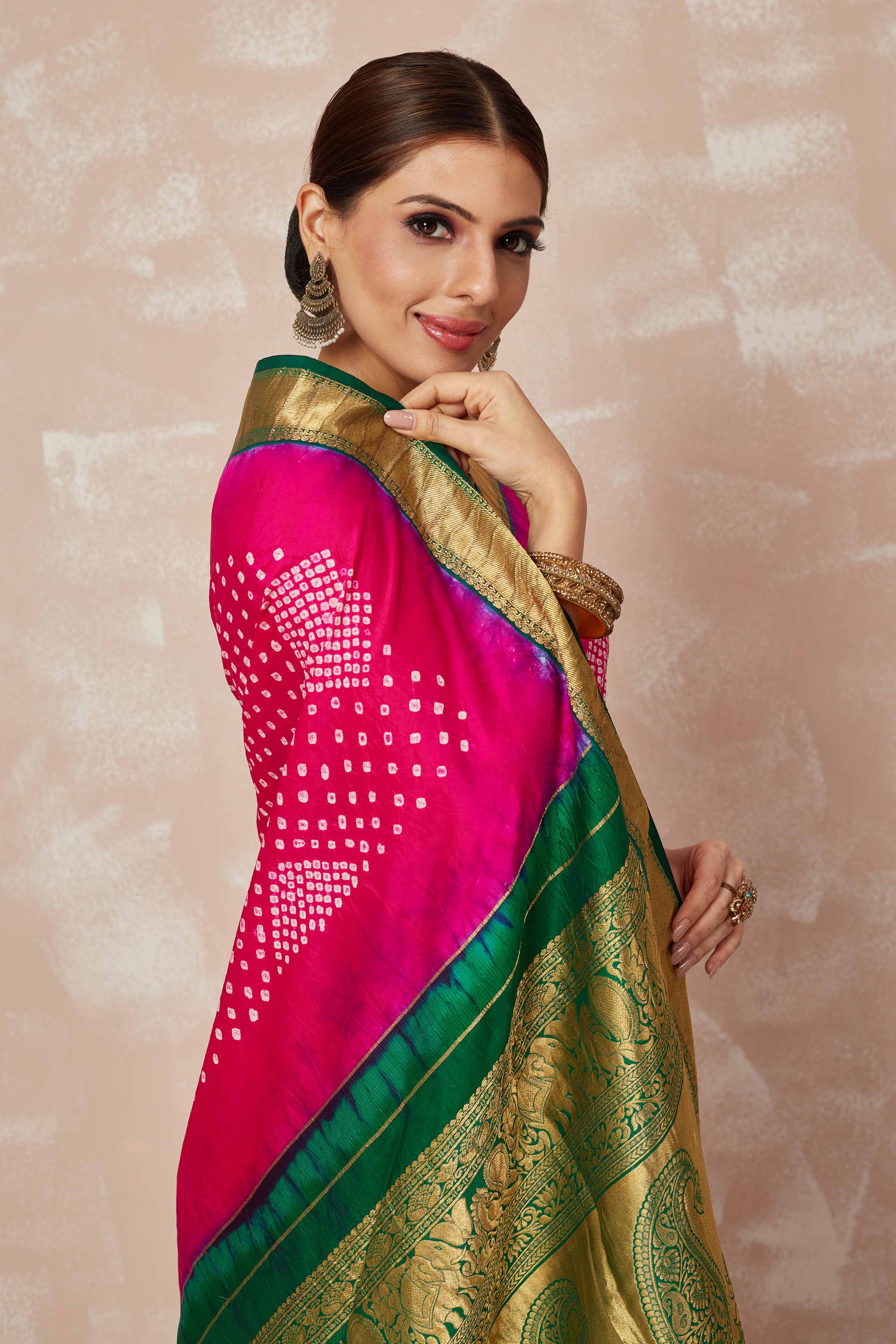 Shop pink bandhej saree online in USA with green zari border and pallu. Look your best on festive occasions in latest designer sarees, pure silk sarees, Kanjivaram silk saris, handwoven saris, tussar silk sarees, embroidered saris from Pure Elegance Indian clothing store in USA.-closeup