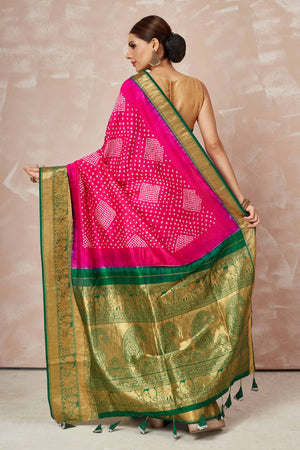 Shop pink bandhej saree online in USA with green zari border and pallu. Look your best on festive occasions in latest designer sarees, pure silk sarees, Kanjivaram silk saris, handwoven saris, tussar silk sarees, embroidered saris from Pure Elegance Indian clothing store in USA.-back