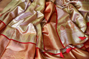 Buy golden heavy Kanjivaram silk sari online in USA with red zari border. Look your best on festive occasions in latest designer sarees, pure silk sarees, Kanjivaram silk saris, handwoven saris, tussar silk sarees, embroidered saris from Pure Elegance Indian clothing store in USA.-closeup