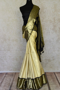 Buy cream Kanjivaram silk saree online in USA with black zari border. Look your best on festive occasions in latest designer sarees, pure silk sarees, Kanjivaram silk saris, handwoven saris, tussar silk sarees, embroidered saris from Pure Elegance Indian clothing store in USA.-full view