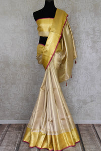 Shop cream Kanjivaram silk saree online in USA with golden zari border. Look your best on festive occasions in latest designer sarees, pure silk sarees, Kanjivaram silk saris, handwoven saris, tussar silk sarees, embroidered saris from Pure Elegance Indian clothing store in USA.-full view