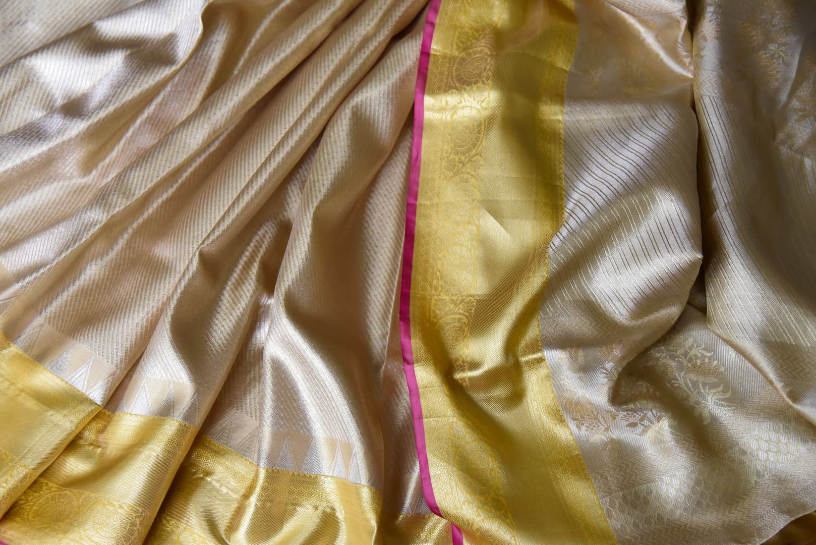 Shop cream Kanjivaram silk saree online in USA with golden zari border. Look your best on festive occasions in latest designer sarees, pure silk sarees, Kanjivaram silk saris, handwoven saris, tussar silk, embroidered saris from Pure Elegance Indian clothing store in USA.- closeup