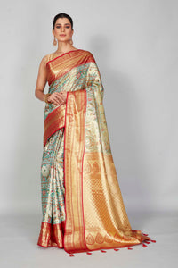 Buy pastel green Kanjeevaram silk sari online in USA with red zari border. Look your best on festive occasions in latest designer saris, pure silk saris, Kanjivaram silk sarees, handwoven saris, tussar silk sarees, embroidered saris from Pure Elegance Indian clothing store in USA.-full view