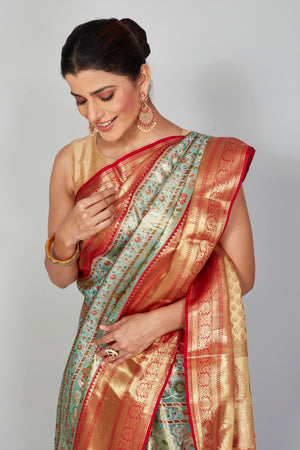 Buy pastel green Kanjeevaram silk sari online in USA with red zari border. Look your best on festive occasions in latest designer saris, pure silk saris, Kanjivaram silk sarees, handwoven saris, tussar silk sarees, embroidered saris from Pure Elegance Indian clothing store in USA.-closeup