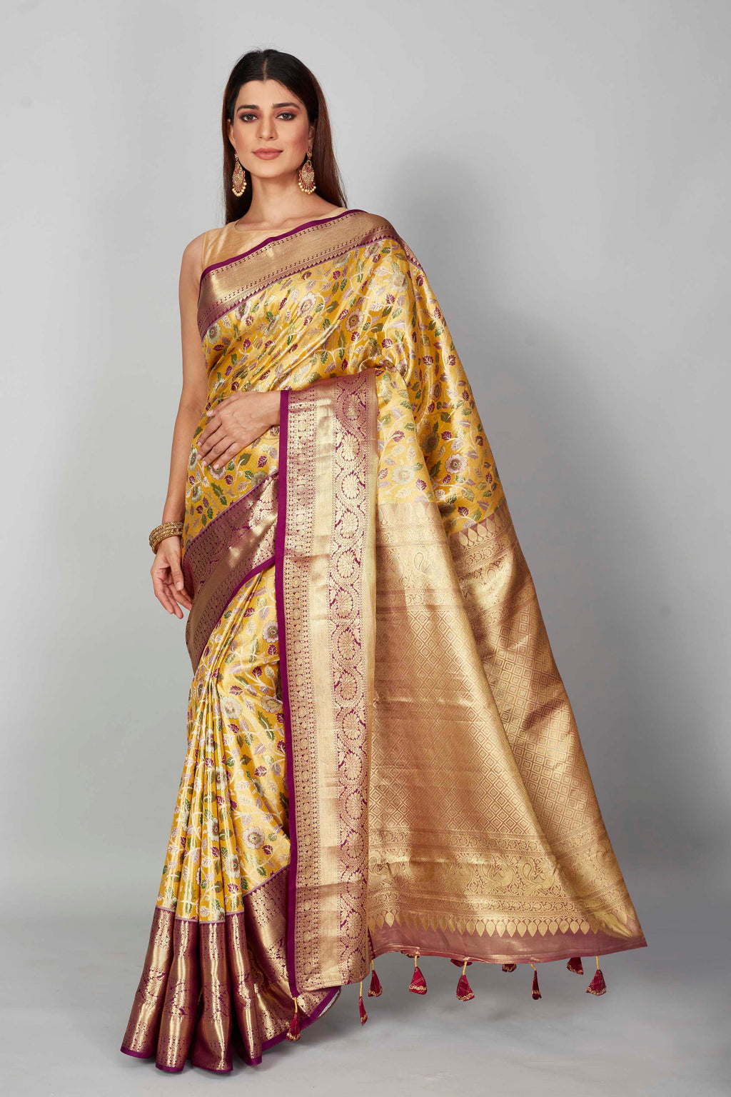 Buy yellow floral Kanjeevaram silk saree online in USA with purple zari border. Look your best on festive occasions in latest designer saris, pure silk saris, Kanjivaram silk sarees, handwoven saris, tussar silk sarees, embroidered saris from Pure Elegance Indian clothing store in USA.-full view