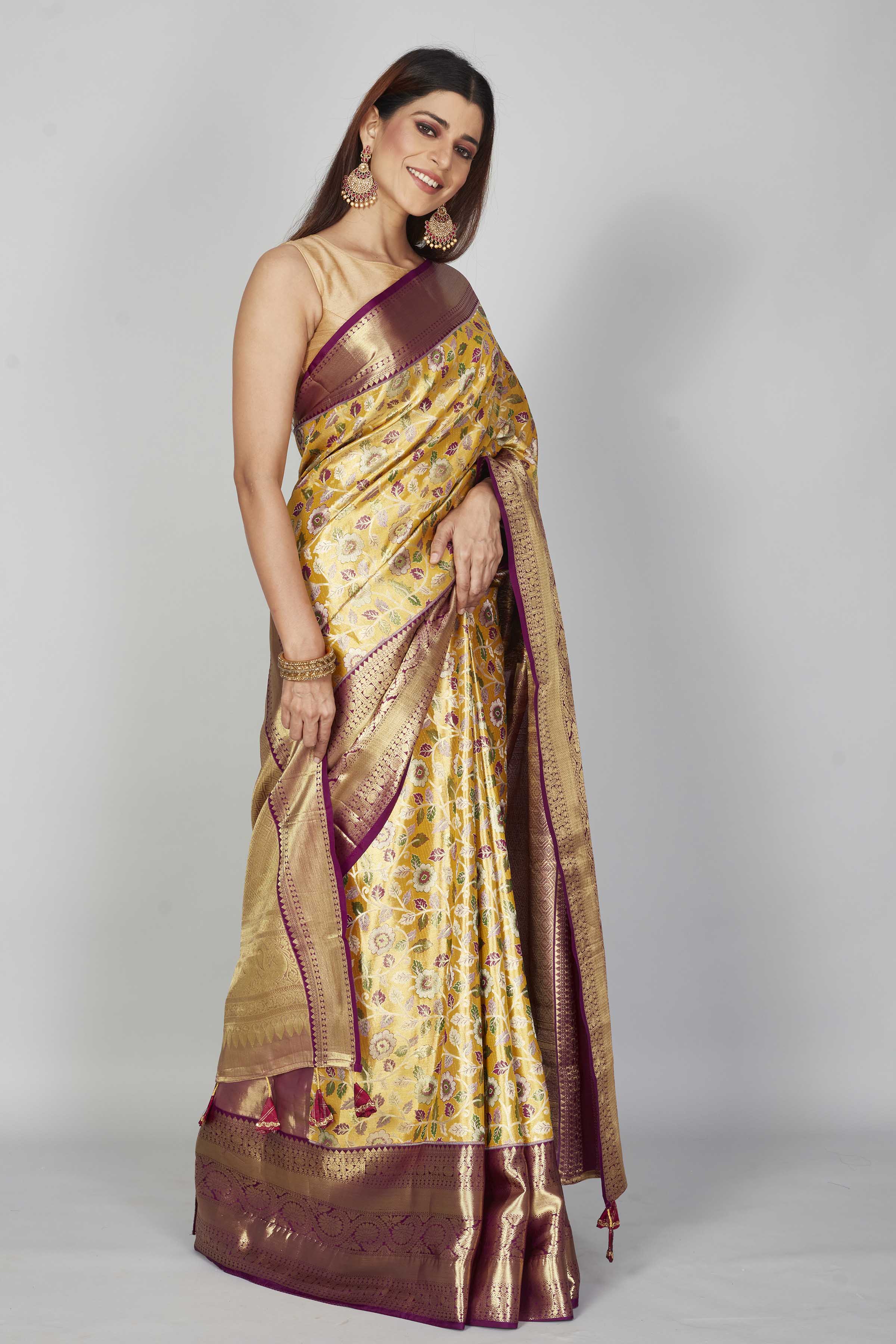 Buy yellow floral Kanjeevaram silk saree online in USA with purple zari border. Look your best on festive occasions in latest designer saris, pure silk saris, Kanjivaram silk sarees, handwoven saris, tussar silk sarees, embroidered saris from Pure Elegance Indian clothing store in USA.-side