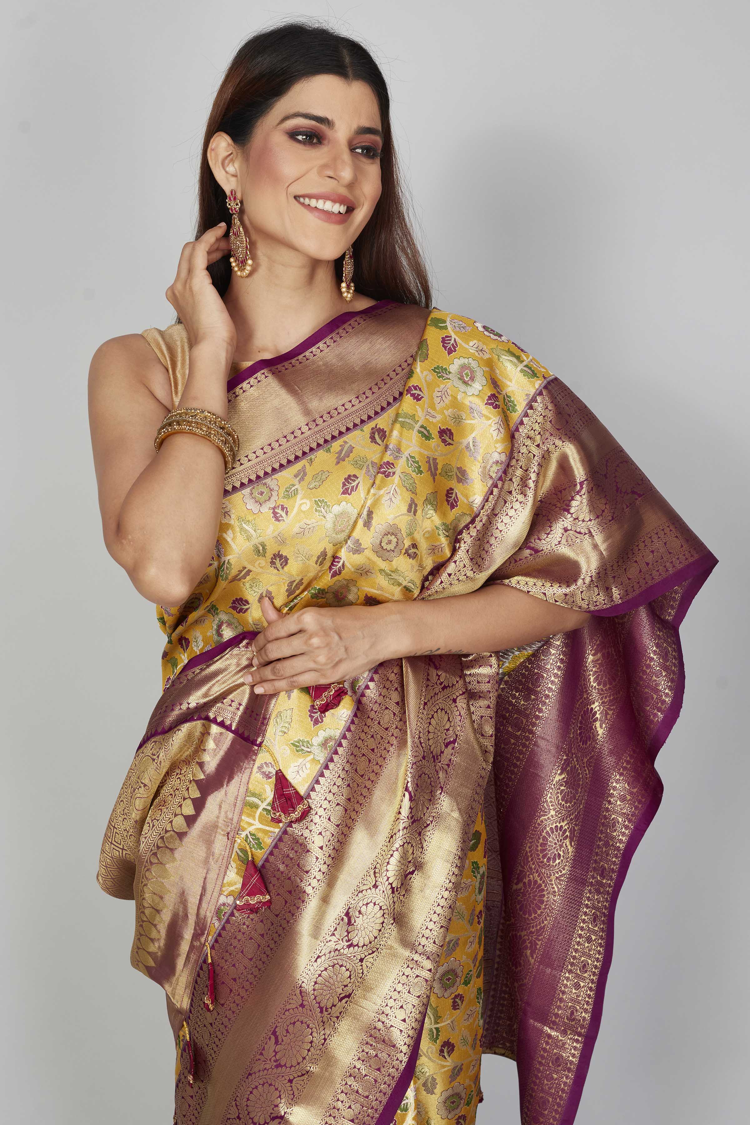 Buy yellow floral Kanjeevaram silk saree online in USA with purple zari border. Look your best on festive occasions in latest designer saris, pure silk saris, Kanjivaram silk sarees, handwoven saris, tussar silk sarees, embroidered saris from Pure Elegance Indian clothing store in USA.-closeup