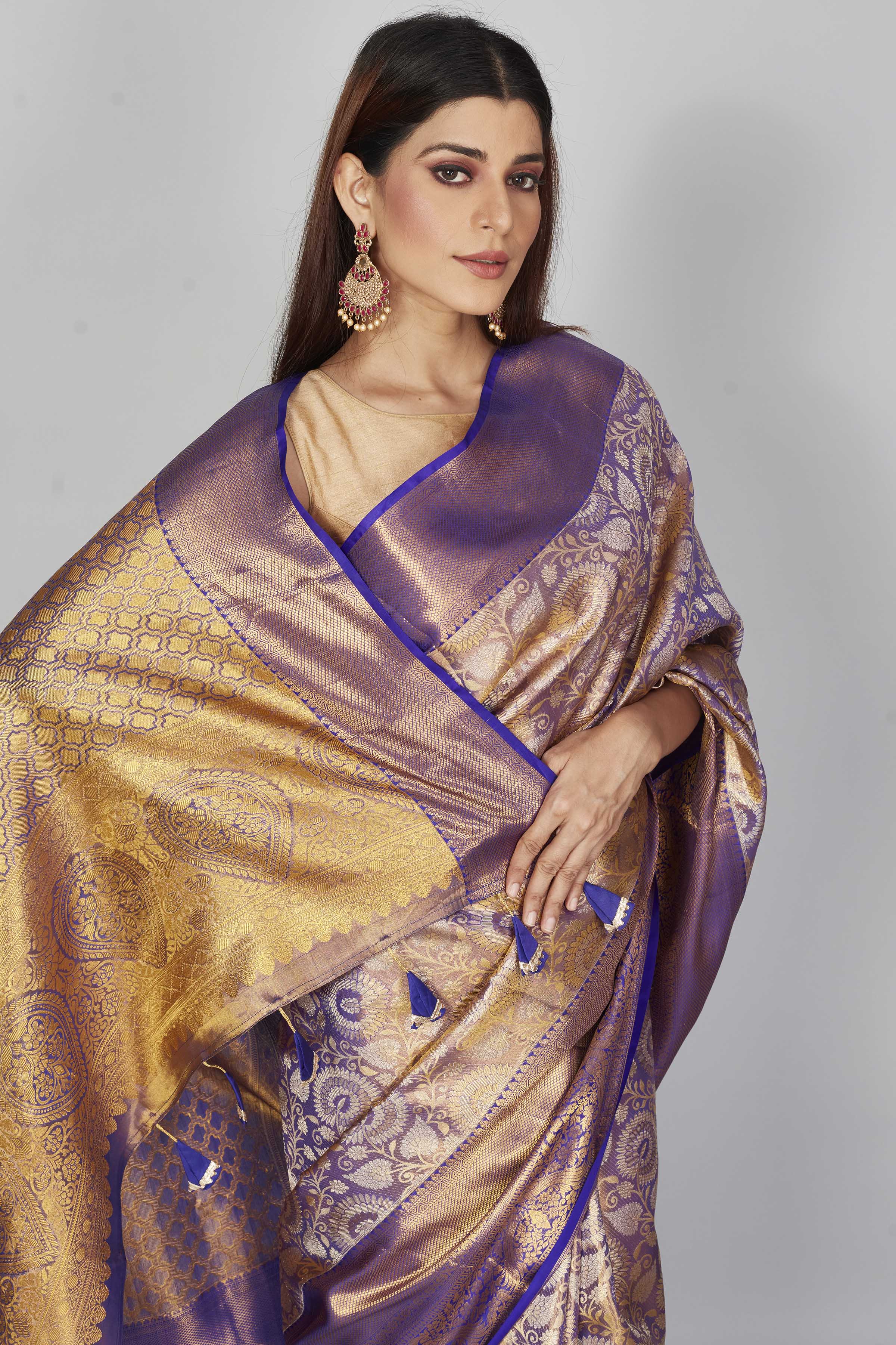 Shop purple heavy Kanchipuram silk sari online in USA with golden zari pallu. Look your best on festive occasions in latest designer saris, pure silk saris, Kanjivaram silk sarees, handwoven saris, tussar silk sarees, embroidered sarees from Pure Elegance Indian clothing store in USA.-closeup