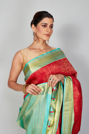 Buy red zari check Kanchipuram silk sari online in USA with blue zari border. Look your best on festive occasions in latest designer saris, pure silk saris, Kanjivaram silk sarees, handwoven saris, tussar silk sarees, embroidered sarees from Pure Elegance Indian clothing store in USA.-closeup