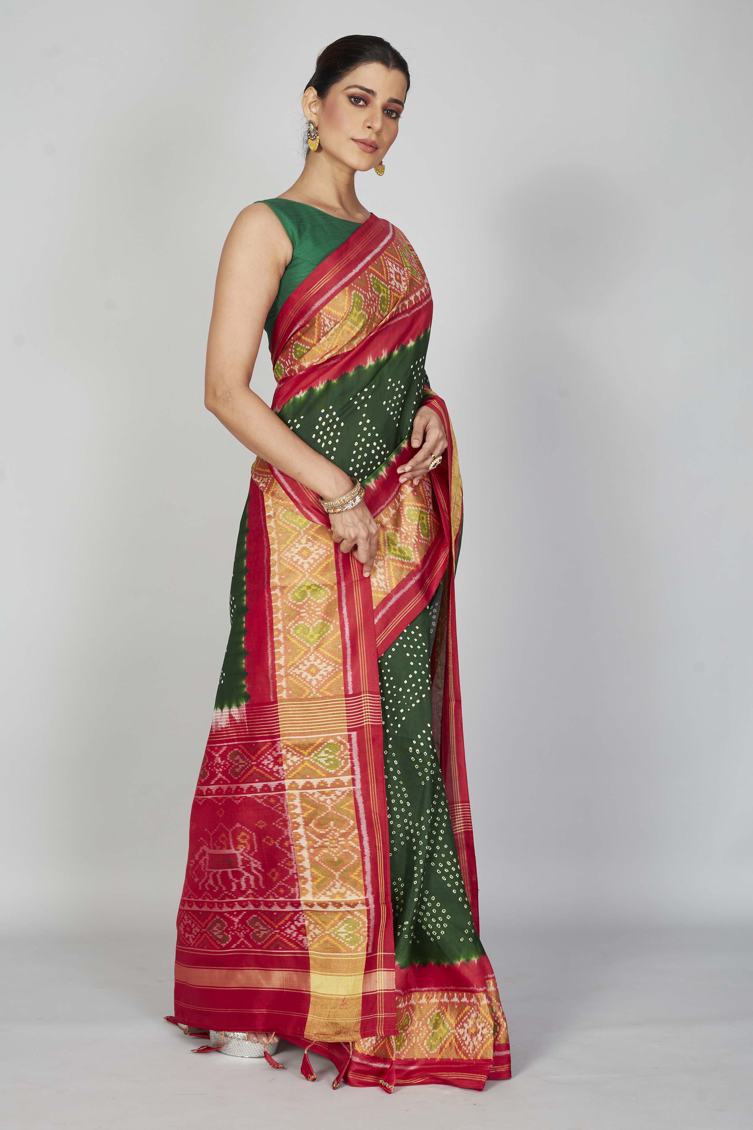 Shop bottle green silk Bandhej sari online in USA with red border. Look your best on festive occasions in latest designer saris, pure silk saris, Kanjivaram silk sarees, handwoven saris, tussar silk sarees, embroidered sarees from Pure Elegance Indian clothing store in USA.-side