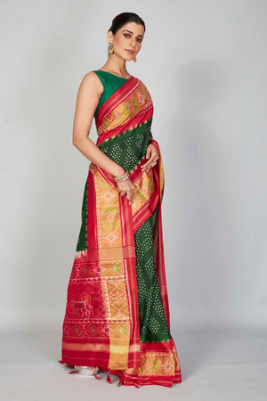 Shop bottle green silk Bandhej sari online in USA with red border. Look your best on festive occasions in latest designer saris, pure silk saris, Kanjivaram silk sarees, handwoven saris, tussar silk sarees, embroidered sarees from Pure Elegance Indian clothing store in USA.-side