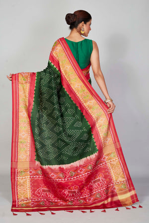 Shop bottle green silk Bandhej sari online in USA with red border. Look your best on festive occasions in latest designer saris, pure silk saris, Kanjivaram silk sarees, handwoven saris, tussar silk sarees, embroidered sarees from Pure Elegance Indian clothing store in USA.-back