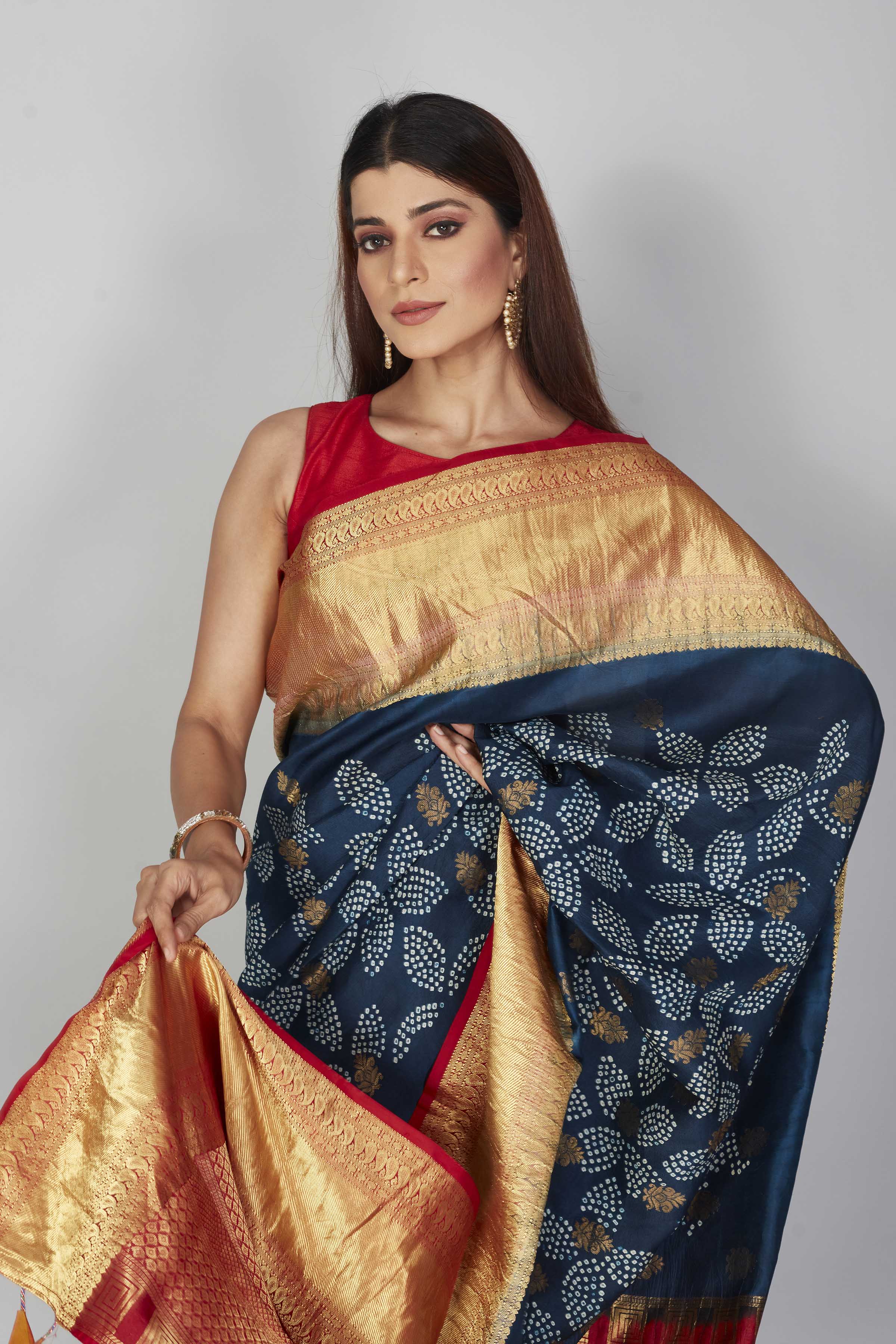 Buy dark blue silk Bandhej sari online in USA with red zari border. Look your best on festive occasions in latest designer saris, pure silk saris, Kanjivaram silk sarees, handwoven saris, tussar silk sarees, embroidered sarees from Pure Elegance Indian clothing store in USA.-closeup