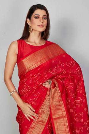 Shop red silk Bandhej sari online in USA with golden zari border. Look your best on festive occasions in latest designer saris, pure silk saris, Kanjivaram silk sarees, handwoven saris, tussar silk sarees, embroidered sarees from Pure Elegance Indian clothing store in USA.-closeup