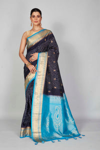 Shop navy blue silk Bandhej sari online in USA with light blue zari border. Look your best on festive occasions in latest designer saris, pure silk saris, Kanjivaram silk sarees, handwoven saris, tussar silk sarees, embroidered sarees from Pure Elegance Indian clothing store in USA.-full view