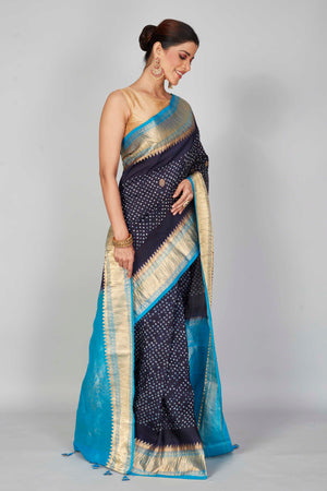 Shop navy blue silk Bandhej sari online in USA with light blue zari border. Look your best on festive occasions in latest designer saris, pure silk saris, Kanjivaram silk sarees, handwoven saris, tussar silk sarees, embroidered sarees from Pure Elegance Indian clothing store in USA.-side