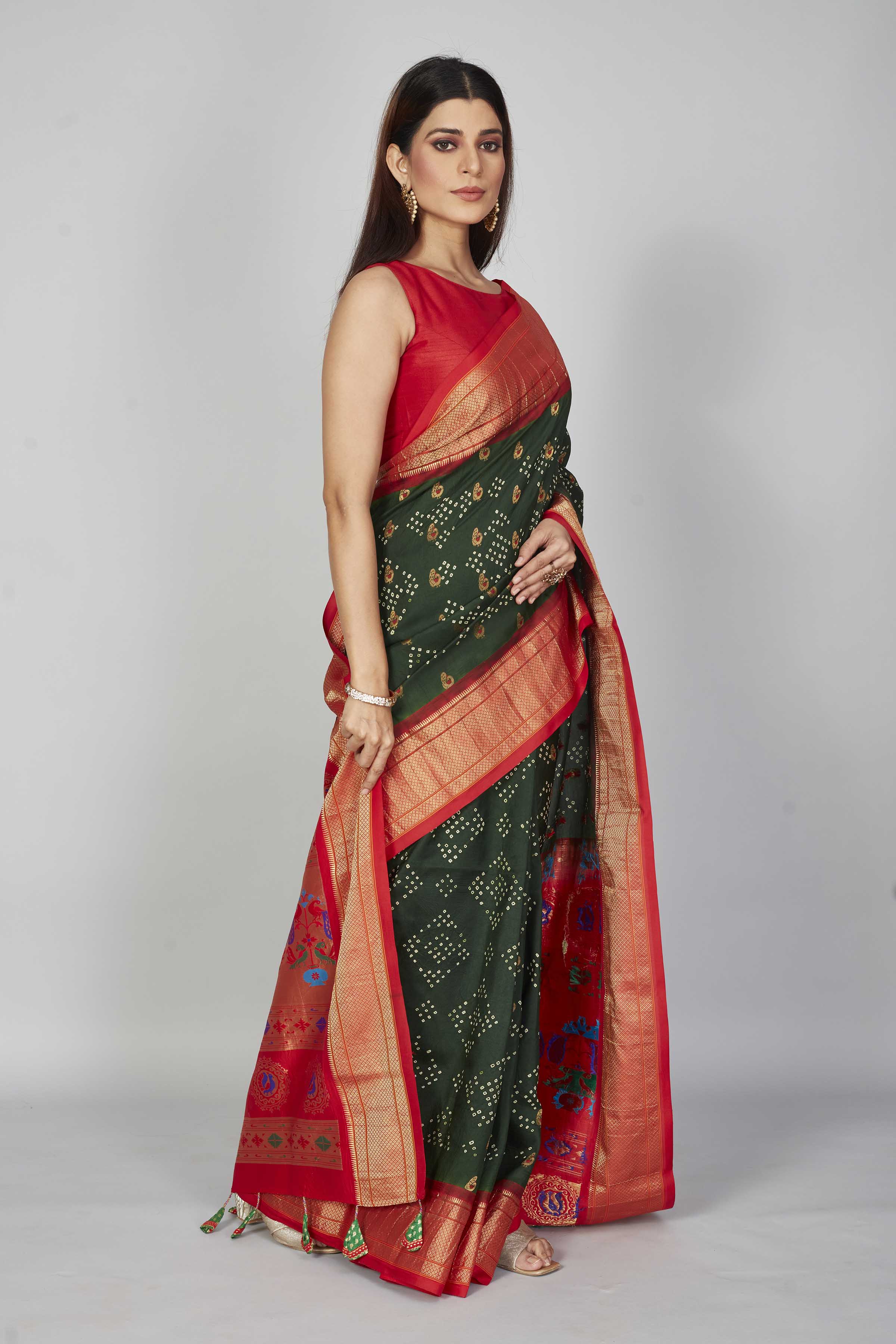 Buy dark green silk Bandhej saree online in USA with red zari border. Look your best on festive occasions in latest designer saris, pure silk saris, Kanjivaram silk sarees, handwoven saris, tussar silk sarees, embroidered sarees from Pure Elegance Indian clothing store in USA.-side