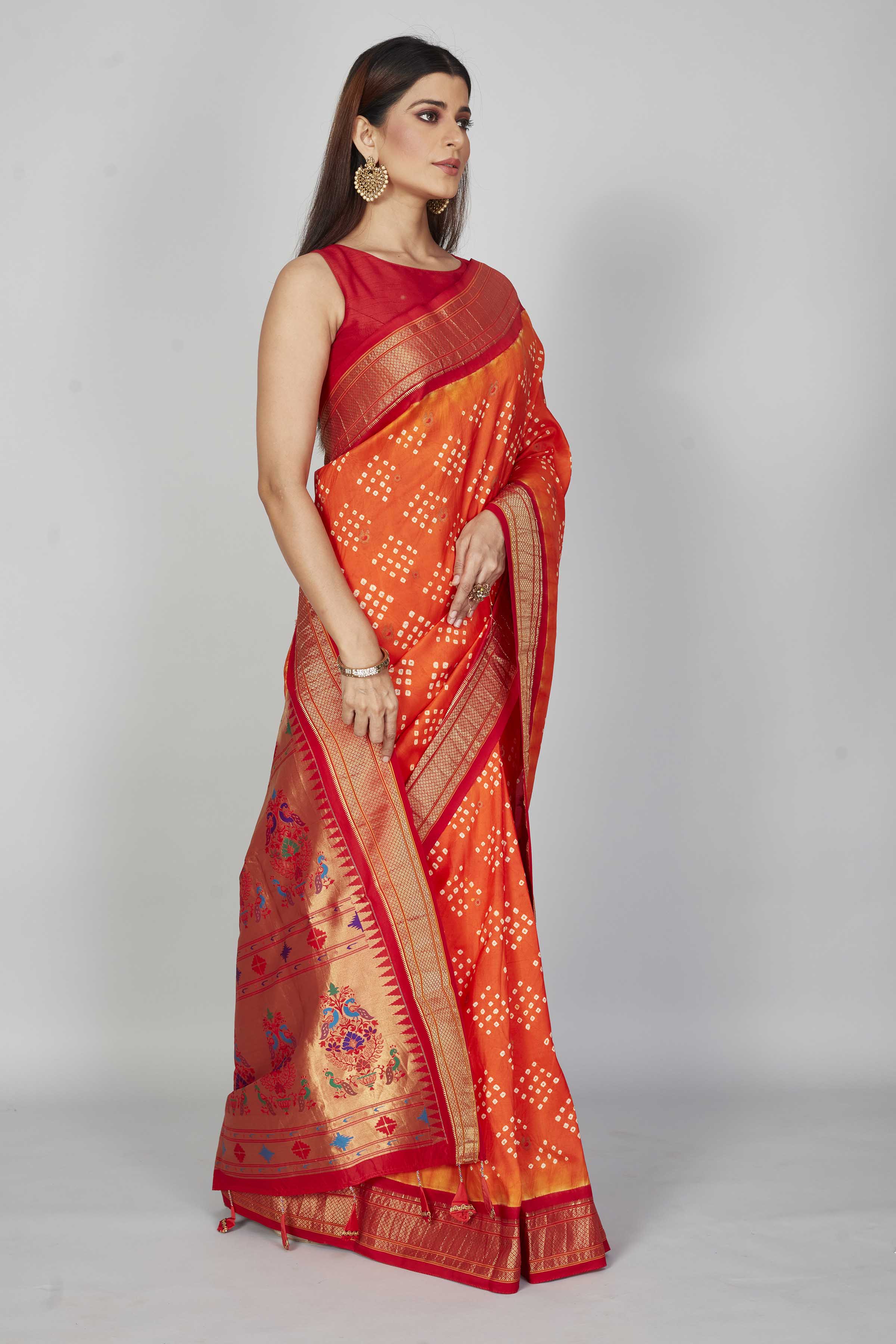 Buy orange Bandhej silk saree online in USA with red zari border. Look your best on festive occasions in latest designer saris, pure silk saris, Kanjivaram silk sarees, handwoven saris, tussar silk sarees, embroidered sarees from Pure Elegance Indian clothing store in USA.-side