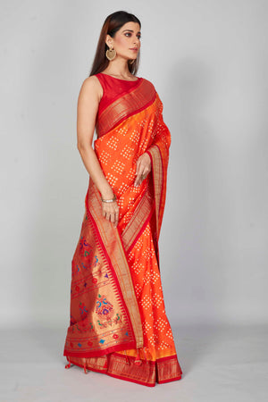 Buy orange Bandhej silk saree online in USA with red zari border. Look your best on festive occasions in latest designer saris, pure silk saris, Kanjivaram silk sarees, handwoven saris, tussar silk sarees, embroidered sarees from Pure Elegance Indian clothing store in USA.-side