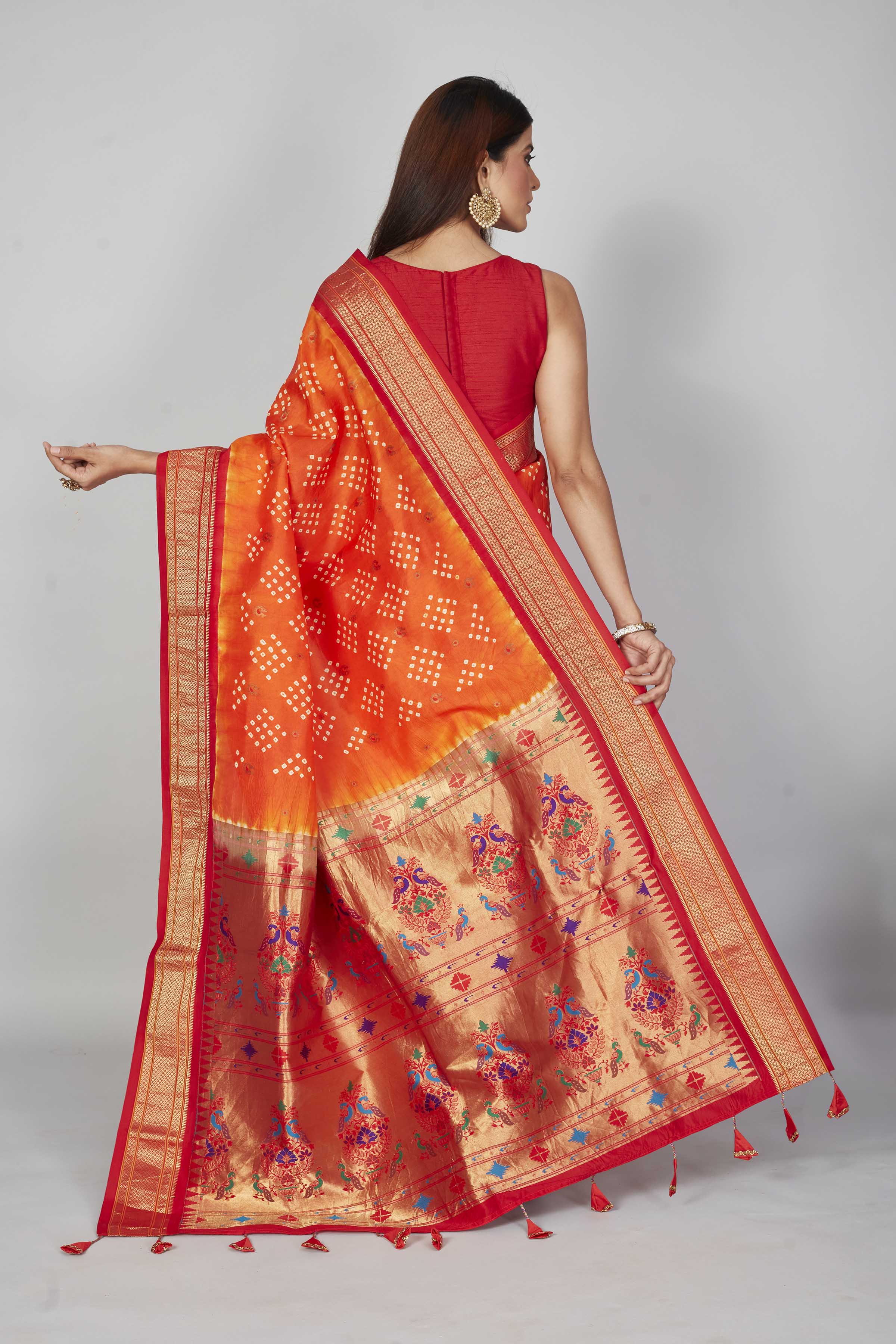 Buy orange Bandhej silk saree online in USA with red zari border. Look your best on festive occasions in latest designer saris, pure silk saris, Kanjivaram silk sarees, handwoven saris, tussar silk sarees, embroidered sarees from Pure Elegance Indian clothing store in USA.-back