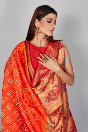 Buy orange Bandhej silk saree online in USA with red zari border. Look your best on festive occasions in latest designer saris, pure silk saris, Kanjivaram silk sarees, handwoven saris, tussar silk sarees, embroidered sarees from Pure Elegance Indian clothing store in USA.-closeup