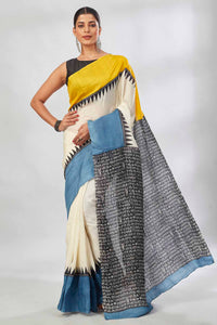 Buy cream batik print saree online in USA with yellow and blue border. Look your best on festive occasions in latest designer saris, pure silk saris, tissue silk sarees, handwoven saris, tussar silk sarees, linen sarees,  summer sarees from Pure Elegance Indian clothing store in USA.-full view