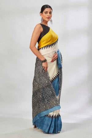 Buy cream batik print saree online in USA with yellow and blue border. Look your best on festive occasions in latest designer saris, pure silk saris, tissue silk sarees, handwoven saris, tussar silk sarees, linen sarees,  summer sarees from Pure Elegance Indian clothing store in USA.-side