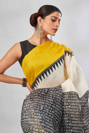 Buy cream batik print saree online in USA with yellow and blue border. Look your best on festive occasions in latest designer saris, pure silk saris, tissue silk sarees, handwoven saris, tussar silk sarees, linen sarees,  summer sarees from Pure Elegance Indian clothing store in USA.-closeup