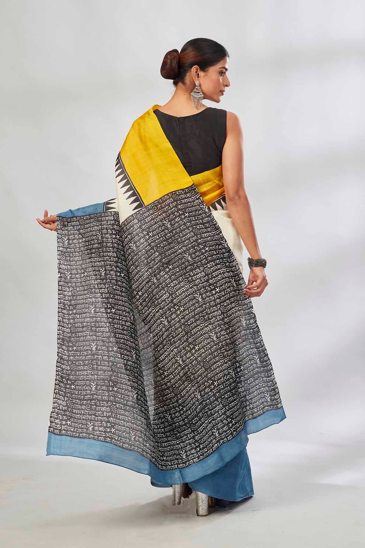 Buy cream batik print saree online in USA with yellow and blue border. Look your best on festive occasions in latest designer saris, pure silk saris, tissue silk sarees, handwoven saris, tussar silk sarees, linen sarees,  summer sarees from Pure Elegance Indian clothing store in USA.-back