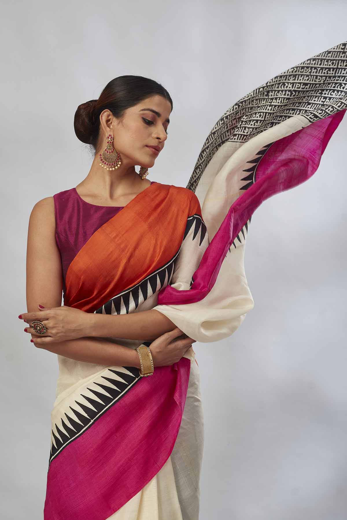 Buy cream batik print saree online in USA with orange and pink border. Look your best on festive occasions in latest designer saris, pure silk saris, tissue silk sarees, handwoven saris, tussar silk sarees, linen sarees,  summer sarees from Pure Elegance Indian clothing store in USA.-closeup