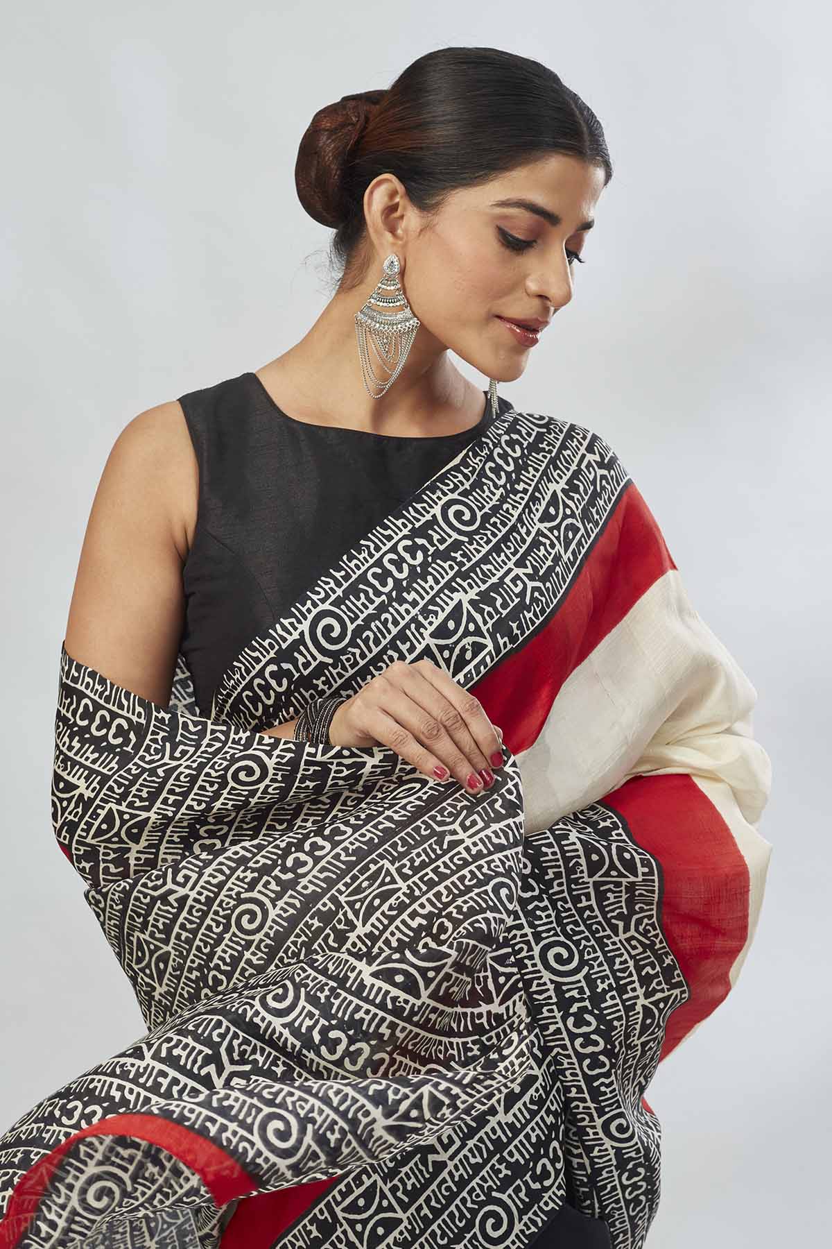 Shop elegant off-white and red black batik print saree online in USA. Look your best on festive occasions in latest designer saris, pure silk saris, tissue silk sarees, handwoven saris, tussar silk sarees, linen sarees,  summer sarees from Pure Elegance Indian clothing store in USA.-closeup