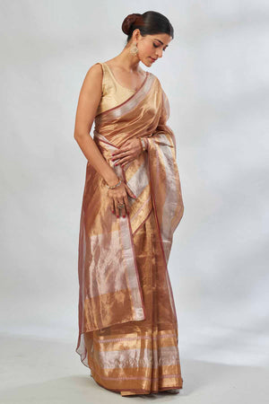 Shop golden tissue silk sari online in USA with silver stripes. Look your best on festive occasions in latest designer saris, pure silk saris, tissue silk sarees, handwoven saris, tussar silk sarees, linen sarees,  summer sarees from Pure Elegance Indian clothing store in USA.-side