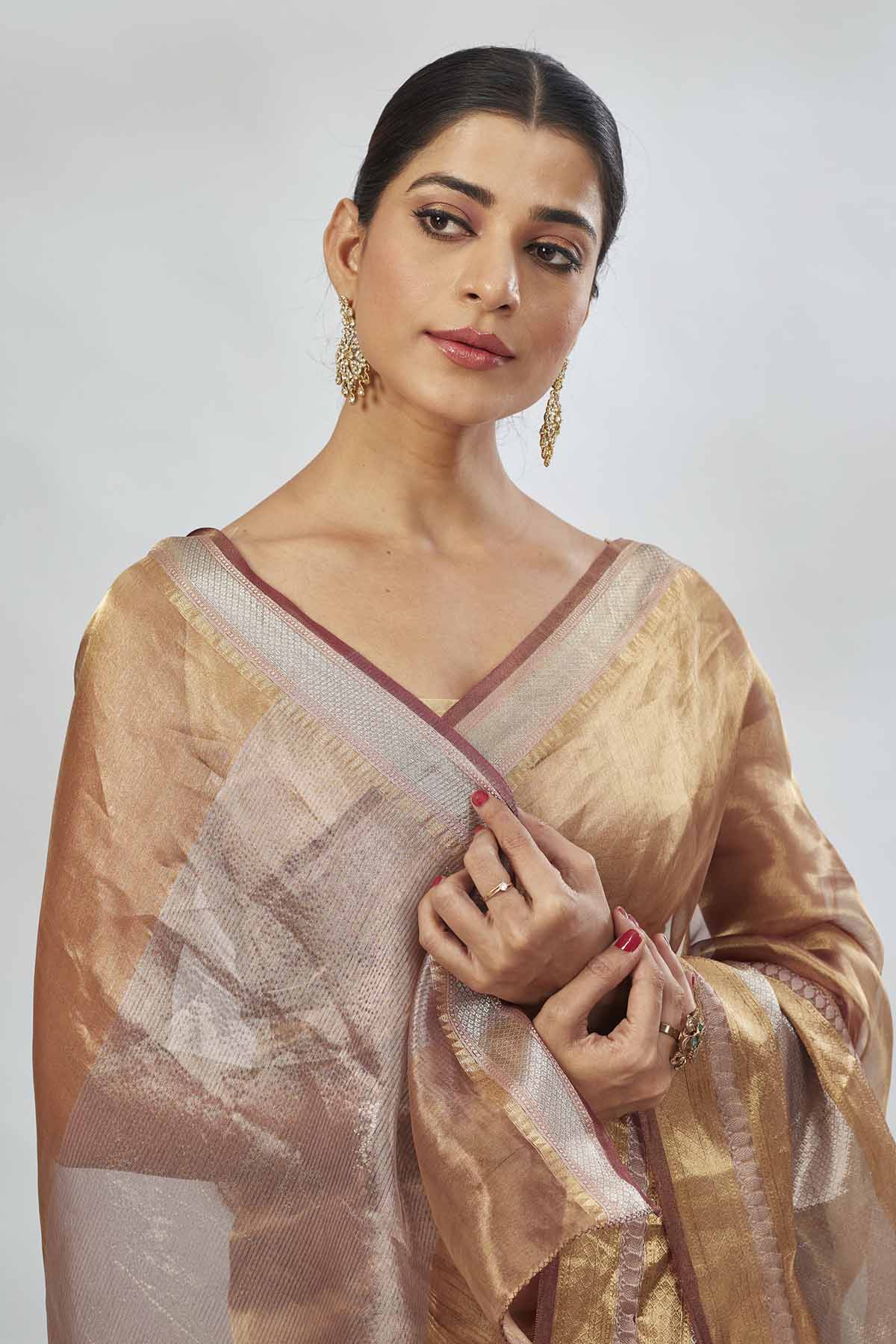 Shop golden tissue silk sari online in USA with silver stripes. Look your best on festive occasions in latest designer saris, pure silk saris, tissue silk sarees, handwoven saris, tussar silk sarees, linen sarees,  summer sarees from Pure Elegance Indian clothing store in USA.-closeup